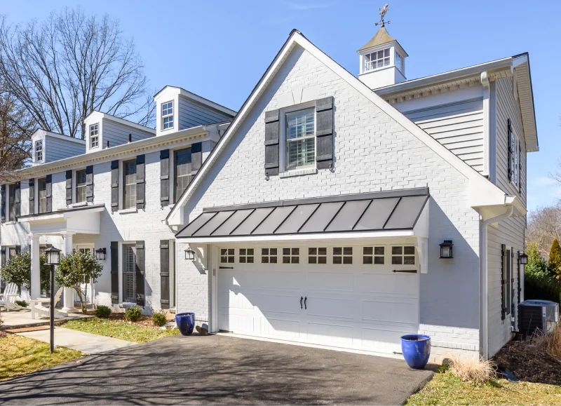 Rendon Remodeling home addition with white brick garage and dormers