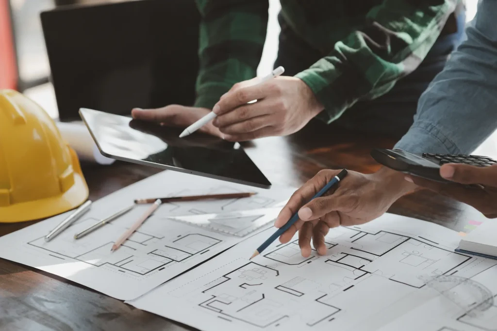 Contractor reviewing remodeling costs, materials, and project scope with a homeowner