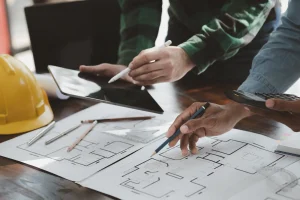 Contractor reviewing remodeling costs, materials, and project scope with a homeowner
